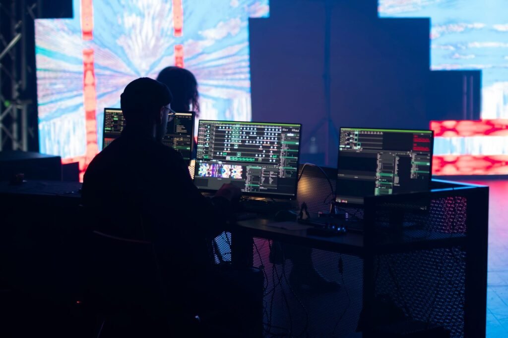 Technician operating visual control equipment in front of an LED wall