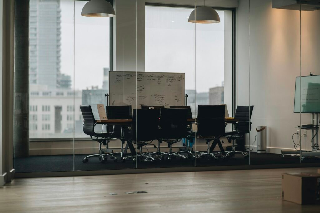 Glass-walled meeting room with a large display