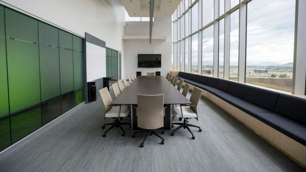 Long meeting room with a wall display and floor-to-ceiling windows