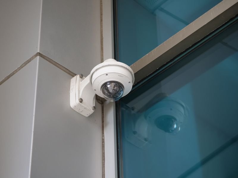 Dome security camera mounted on a modern building corner